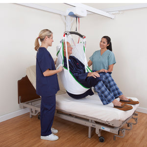 Prism Medical C-450 Ceiling Lift patient in sling by Handicare | VIVA Mobility